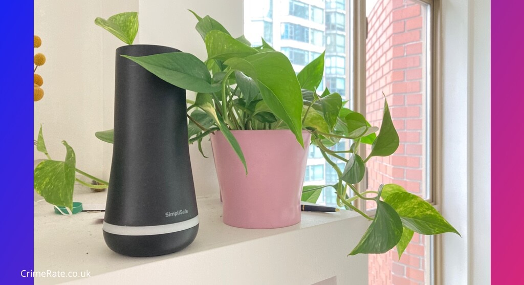 Photograph of a SimpliSafe alarm hub on a mantle next to a plant. 