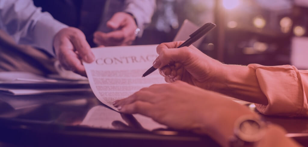 Hands signing contract. 